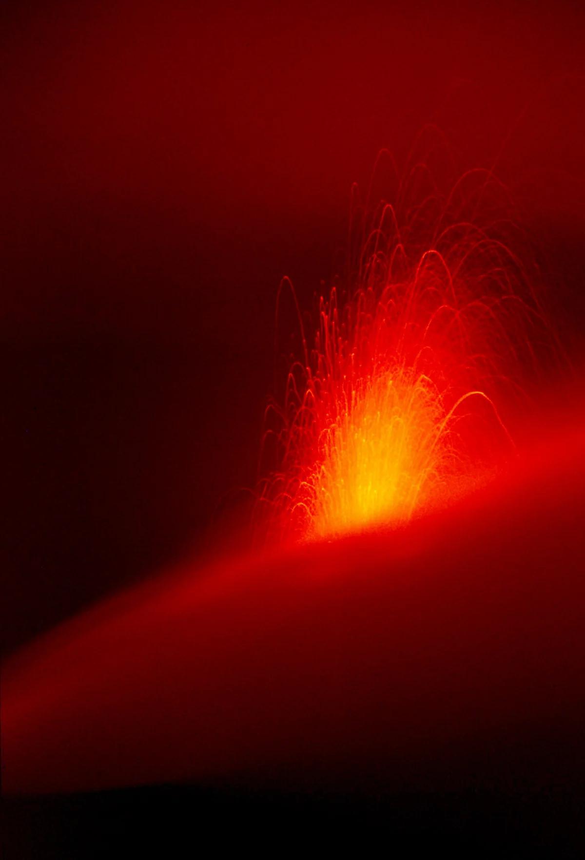 A night eruption of the Stromboli volcano in a long exposure seen from high on the mountain, Aeolian Islands, Italy