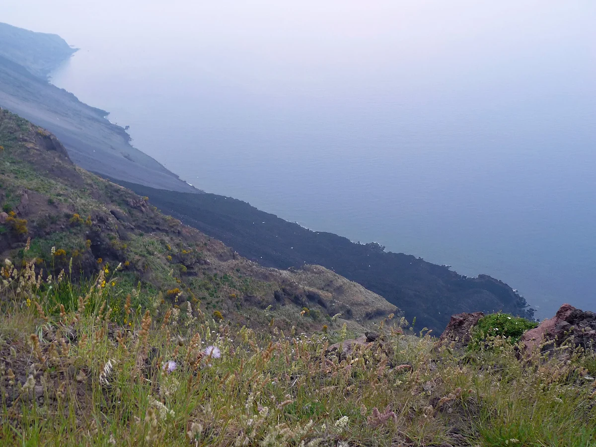 Dusk over the Sciara del Fuoco slope of the Stromboli volcano watched from the sea, Aeolian Islands, Italy